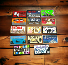 Load image into Gallery viewer, A collection of colorful wooden signs with different book genres indicated, displayed on a wooden surface.
